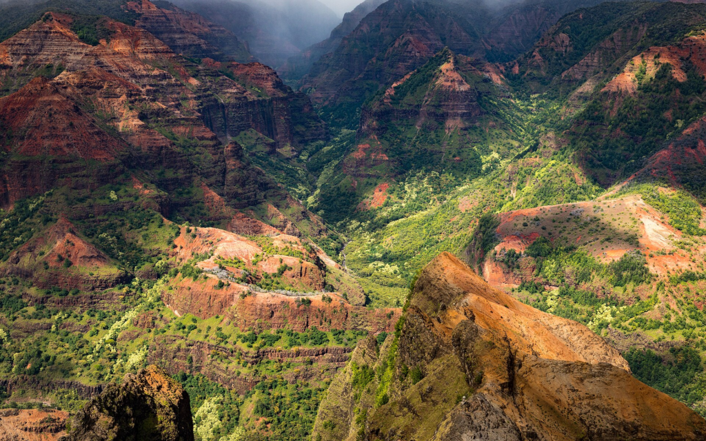 Kauaʻi Travel Guide Waimea Canyon with red cliffs and green ridges on Kauaʻi